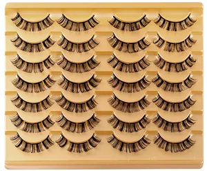 Detailed macro view of 14 pairs of D-curl segmented false eyelashes on a gold tray