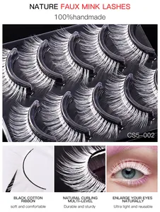 Close-up of 5 pairs of white handmade false eyelashes with a black cotton band and 3D curl