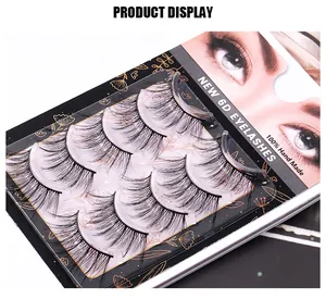 Detailed view of five pairs of 6D handmade synthetic fiber eyelashes on gold floral packaging