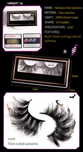 Close-up of handmade Halloween eyelashes with bat and moon charms in premium packaging
