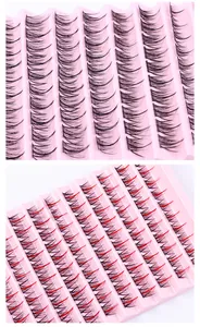 Detail view of segmented black and red lash extensions in a large pink tray