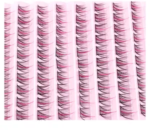 Macro shot of two-tone black and pink individual eyelash clusters on a pink tray