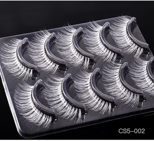 Detail view of 5 pairs of dramatic white fiber false eyelashes for stage and party makeup