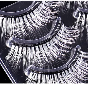 Macro detail of white faux fiber eyelashes for cosplay and stage makeup on black base
