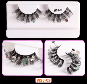 Macro view of Halloween false eyelashes with skull and ghost decals on black fibers