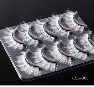 Close-up of five pairs of thick white synthetic fiber false eyelashes for stage makeup