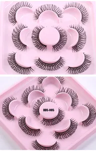 Close-up of 5 pairs of voluminous Russian DD curl false eyelashes on a pink tray