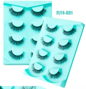 Détail de 4 paires de faux cils volumineux et recourbés sur support menthe