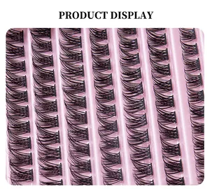 Macro detail of natural C-curl individual lash clusters arranged on pink tray