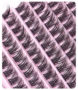 Macro shot of natural C-curl individual lash clusters arranged on a pink tray base