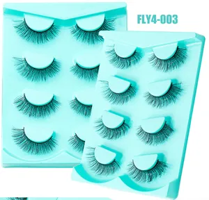 Vue détaillée de 4 paires de faux cils épais en imitation vison sur deux plateaux bleus