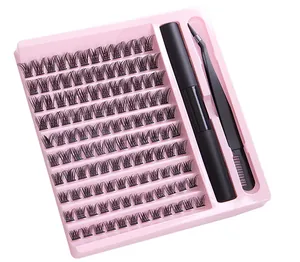 Macro shot of 10-row cluster fake eyelashes set with glue and tweezers in pink tray