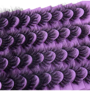 Detailed close-up of voluminous 3D black false eyelashes on purple multi-tier trays