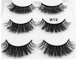 Detailed macro view of 3 pairs of thick R12 false eyelashes on white plastic tray
