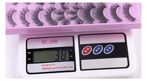 Detailed view of 20 pairs of fluffy faux mink eyelashes weighing 38g on a digital scale