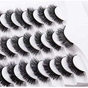 Detailed close-up of 12 pairs thick and curly false eyelashes on a white plastic tray