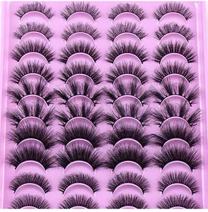 Macro shot of 10 pairs of dense curly faux mink eyelashes on pink tray background
