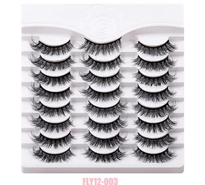 Detailed close-up of 12 pairs fluffy natural long curly false eyelashes on white display tray