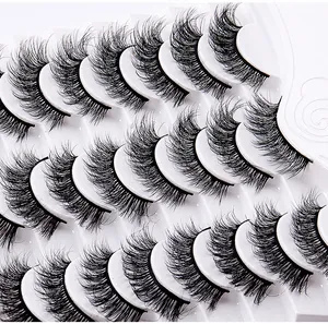 Macro detail of 14 pairs of fluffy volume false eyelashes in a white plastic tray display
