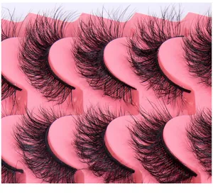 Detailed macro view of 5 pairs of thick crisscross faux mink eyelashes on a pink tray