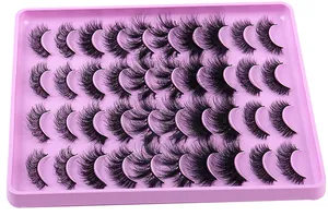 Macro view of 20 pairs of dense faux mink eyelashes arranged in a pink display tray