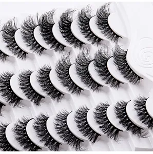 Macro view of voluminous 12-pair false eyelash set with dense curly black synthetic fibers