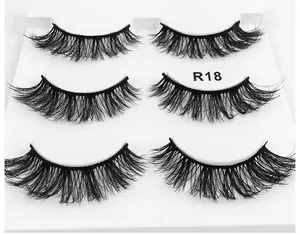 Detailed view of R18 6D fluffy false eyelashes set with three pairs in a white tray