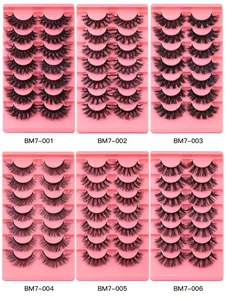 Macro display of 7-pair faux mink eyelash sets with curly dense textures in pink trays