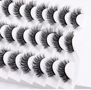 Detail of 14 pairs of fluffy wispy false eyelashes on white textured display tray