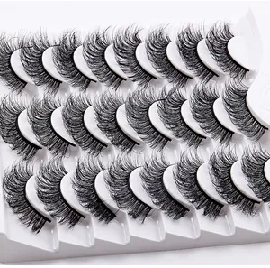 Detailed view of dense and curly black false eyelashes set on a white plastic tray