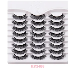 Detailed macro view of 12 pairs of dense, fluffy crisscross false eyelashes on tray