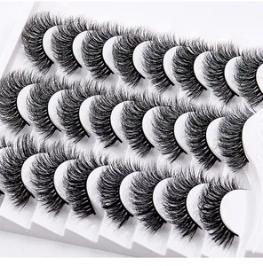 Macro shot of 15 pairs of dense curly false eyelashes in a white professional tray