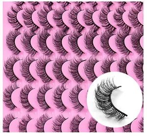 Close-up of 30 pairs natural wispy false eyelashes with thick curls in pink tray
