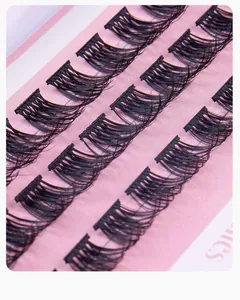 Macro detail of dense black individual lash clusters arranged on a purple card