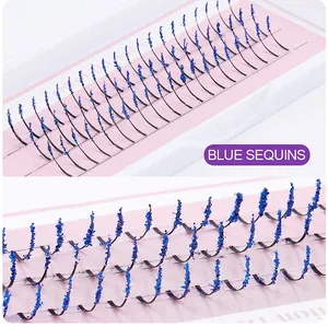 Macro detail of individual cluster eyelashes with vibrant blue glitter sequins decoration