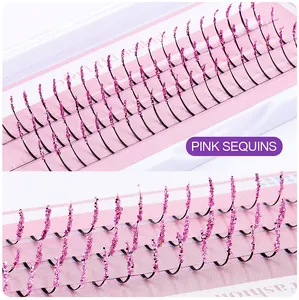 Macro detail of individual cluster eyelashes featuring sparkling pink glitter accents