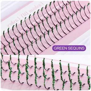 Macro detail of DIY lash extensions with dense green sequins on a pink background