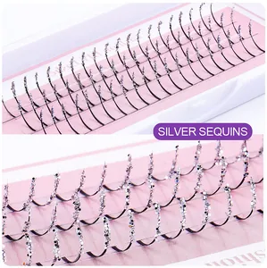 Macro detail of false eyelashes featuring silver sequins and a natural curled finish