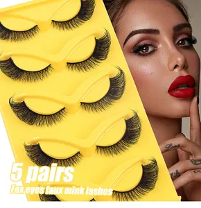 Detail of 5 pairs of fox eyes faux mink lashes in a vibrant yellow tray with dramatic curl