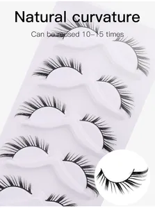 Detailed macro view of 5 pairs of thick curly black false eyelashes on a white tray