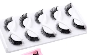 Close-up detail of 5 pairs of thick winged faux mink lashes on a white tray
