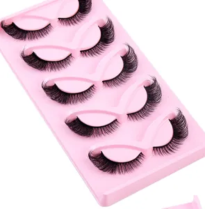 Macro detail of 5 pairs of thick winged faux mink eyelashes on a pink display tray
