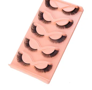 Close-up of five pairs of winged fox-eye false eyelashes in a pink display tray