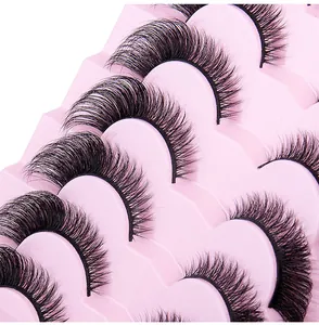 Detailed macro view of 7 pairs of cross-layered fox eye false eyelashes on a pink tray