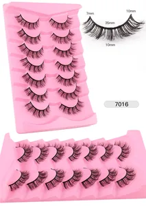 Detailed view of 7 pairs of 7-10mm messy faux mink eyelashes on a pink tray