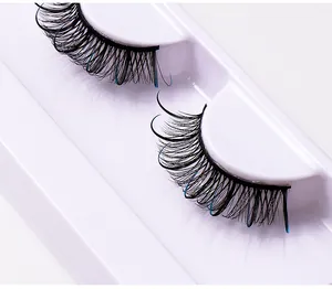 Macro view of thick crisscross false eyelashes with blue fibers in a white tray