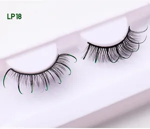 Detail of LP18 black false eyelashes with green glitter tips on a white display tray