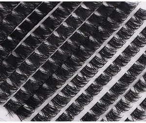 Close-up of multiple rows of dense black synthetic cluster eyelashes with natural curl