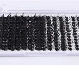 Detailed close-up of DIY segment eyelash clusters in a white tray for professional eye makeup