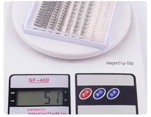 Macro shot of DIY cluster eyelashes combination pack on a scale showing 51g weight